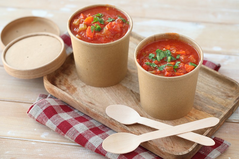 用一次性紙杯盛西紅柿湯，木托盤和木勺子圖片素材