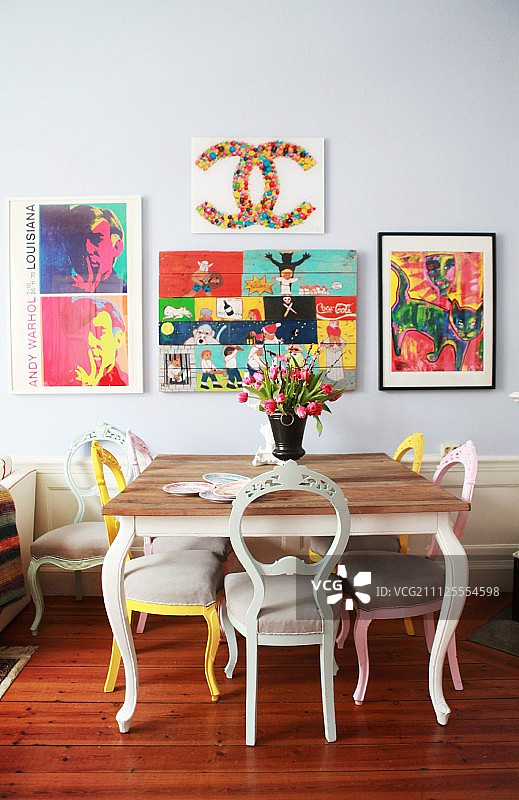 餐厅区，古色古香的椅子上涂着各种颜色，浅灰色的墙壁上有五颜六色的图画图片素材