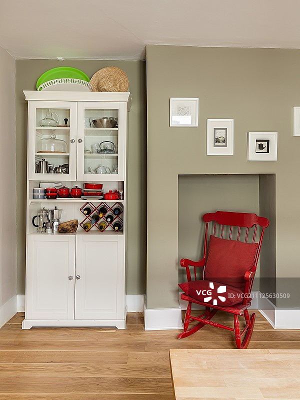 厨房梳妆台旁边的壁龛里有一把红色的摇椅图片素材