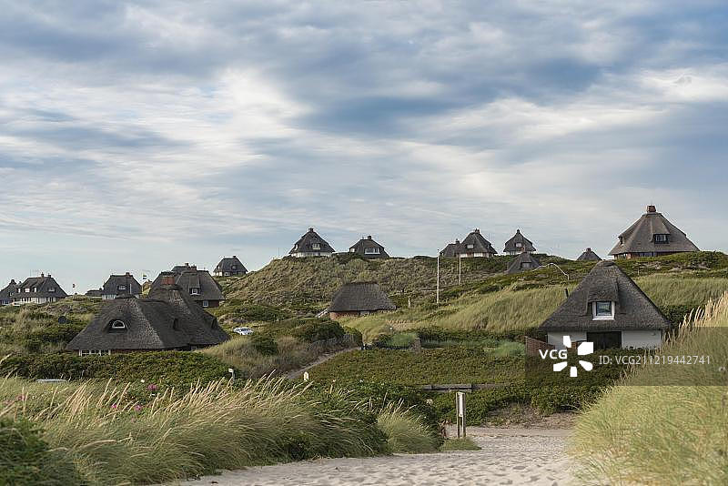欧洲德国石勒苏益格-荷尔斯泰因，北弗里斯兰，希尔特，霍纳姆，霍纳姆前面沙丘上的茅草小屋图片素材