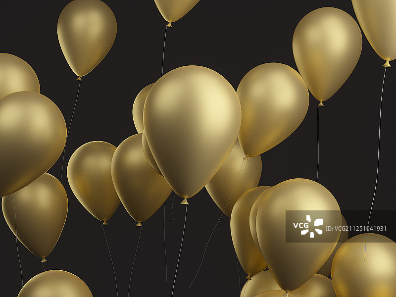 节日庆典用的金色的气球漂浮在黑底背景的空中图片素材