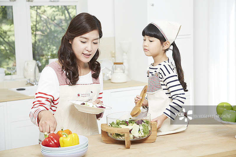 母亲和女儿在厨房做饭的照片图片素材