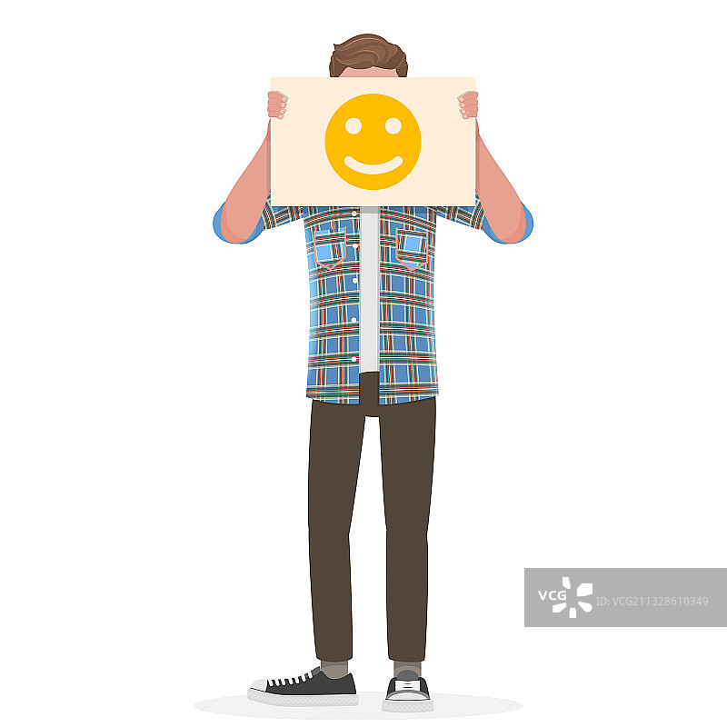 一个男人在他的面前举着一个快乐的表情符号图片素材