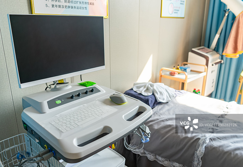 中国医疗器械拍摄主题，一位医生坐在一台用于给病人检查身体的医疗仪器前操作设备用品，室内图像摄影图片素材