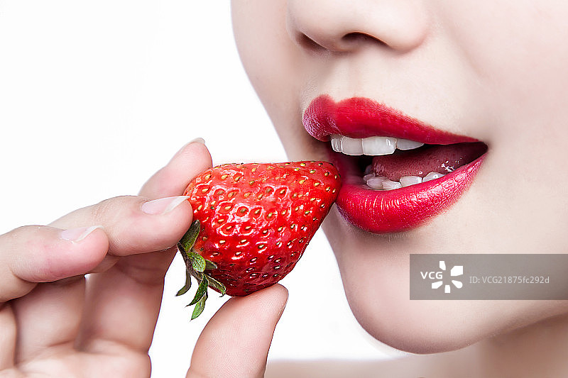 Woman eating a strawberry图片素材