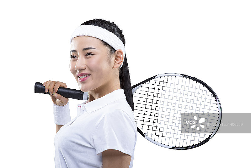 Young female tennis player with tennis racket on shoulder图片素材