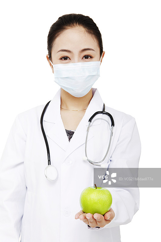 东方年轻女医生拿着一个青苹果图片素材