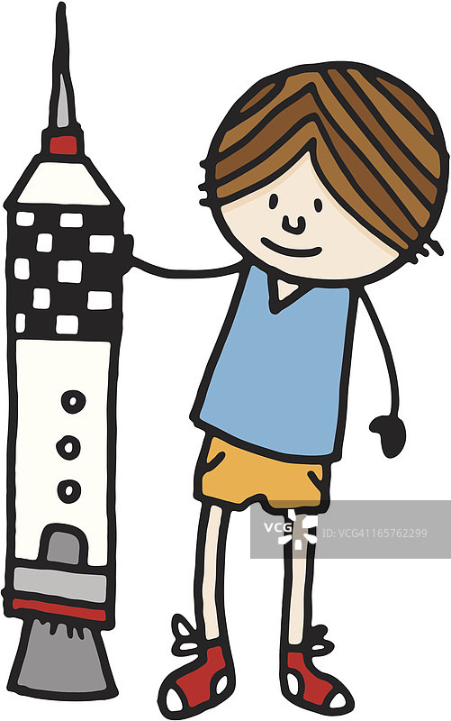 男孩站在一个大型玩具火箭旁边图片素材