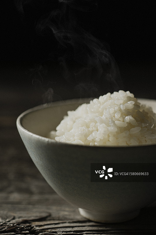 米饭放在碗里，放在木头上图片素材