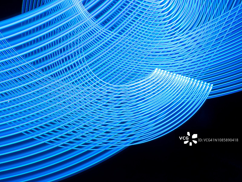蓝色的曲线在3D中形成一个网。光绘图片素材