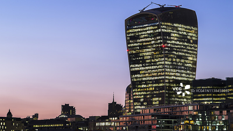 伦敦的现代建筑在黄昏时灯火通明图片素材