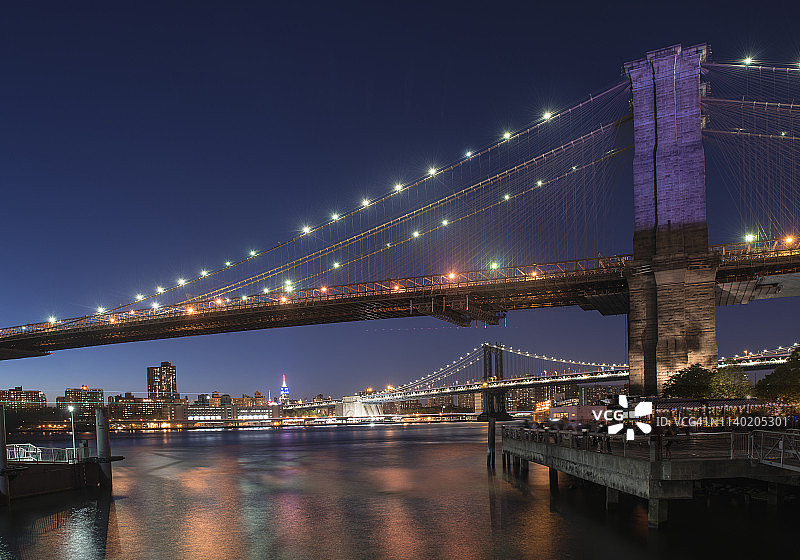 布鲁克林和曼哈顿桥在夜晚的光，曼哈顿，纽约，美国图片素材