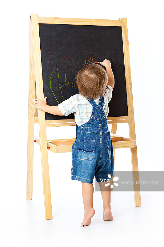男孩正在黑板上画画图片素材