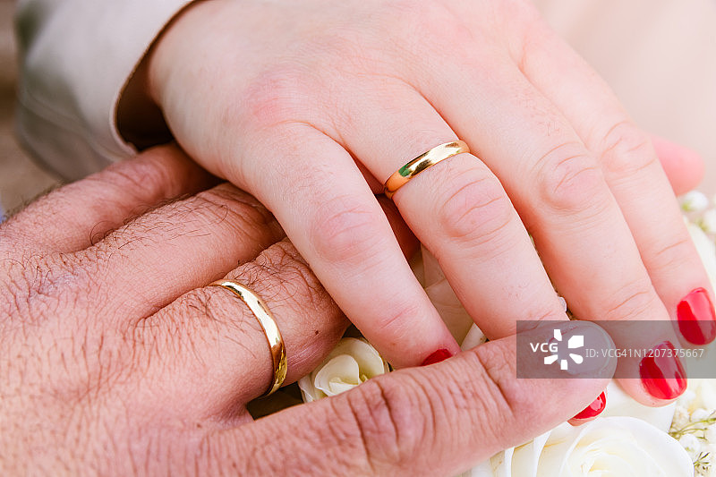 戴着结婚戒指的新婚夫妇的手图片素材
