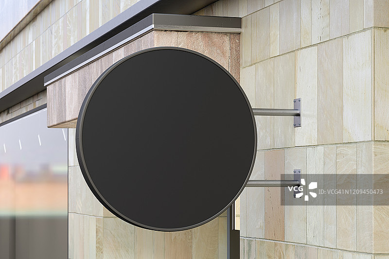 圆形的招牌或标志在大理石墙上与空白的黑色标志模拟。侧视图。图片素材