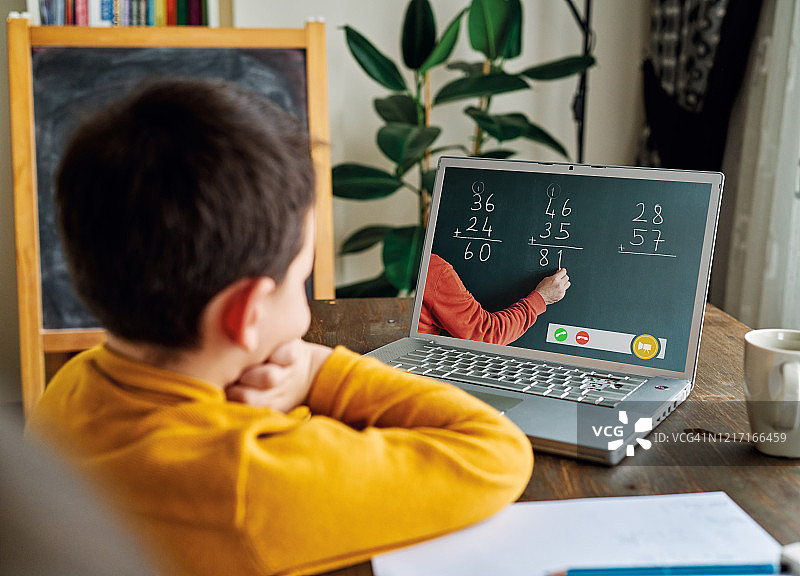 6-7岁可爱的孩子从电脑学习数学。图片素材