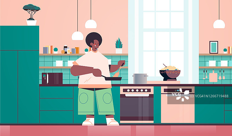 快乐的男人在家里准备健康的食物烹饪概念现代厨房内部图片素材