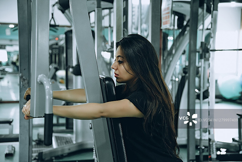 亚洲年轻女性在健身房锻炼图片素材