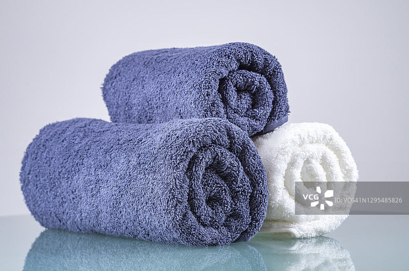 毛巾，卷起的白色和蓝色的蓬松毛巾，美容和按摩水疗概念，豪华酒店的特写图片素材