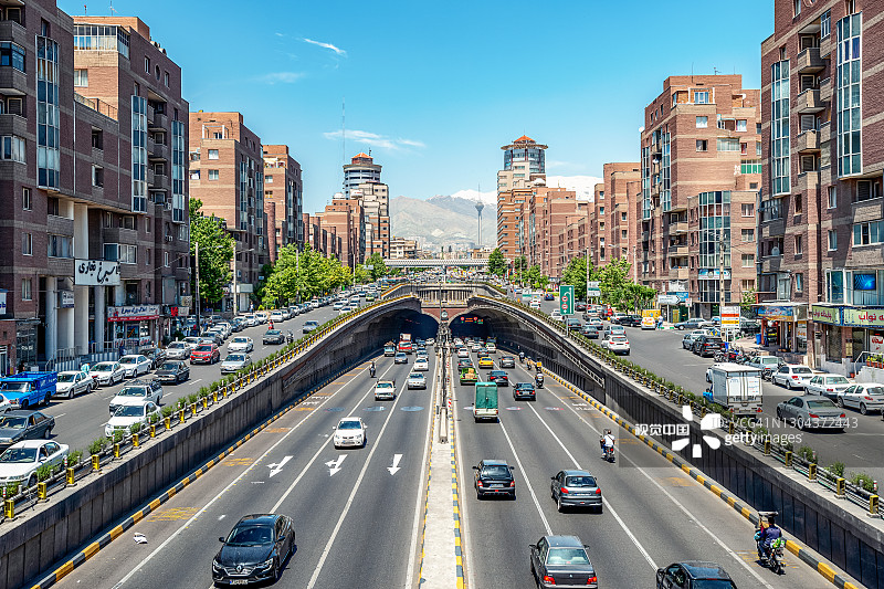 06/05/2019德黑兰，伊朗，著名的德黑兰，内部的交通流量，上方和附近的Tohid隧道，以米拉德塔和阿尔伯兹山为背景，Tohid隧道是中东最长的城市隧道之一图片素材