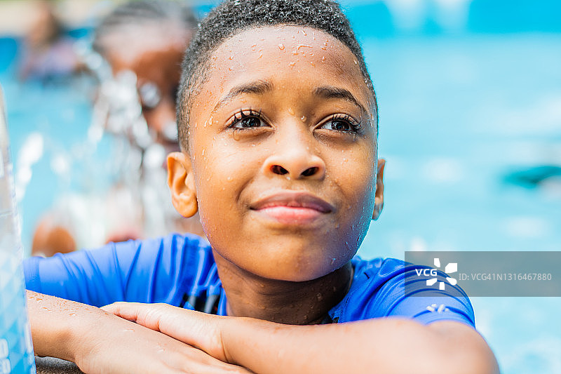 一个非裔美国男孩在泳池里的肖像图片素材