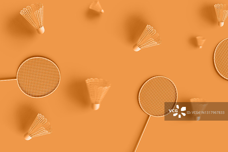 羽毛球拍和羽毛球在橙色的表面图片素材