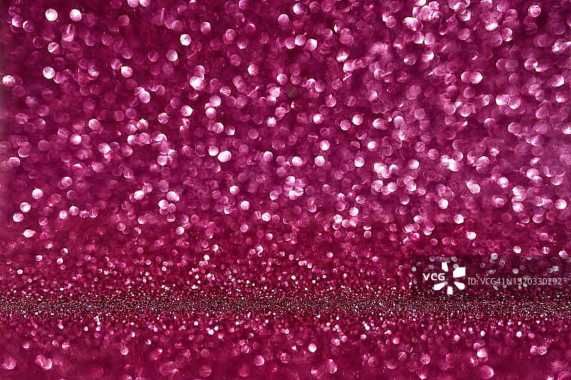 美丽的粉红色假日背景与闪闪发光和焦点灯新年，圣诞节或生日。图片素材