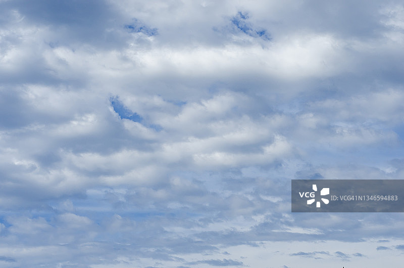 全画框的低角度视图，白色的云与蓝色的天空。图片素材
