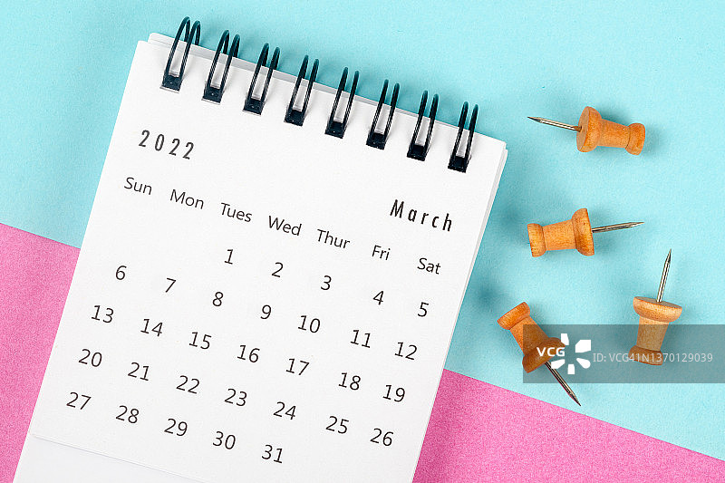 2022年3月是组织者计划和截止日期的月份，在双色纸背景上有一个图钉。图片素材
