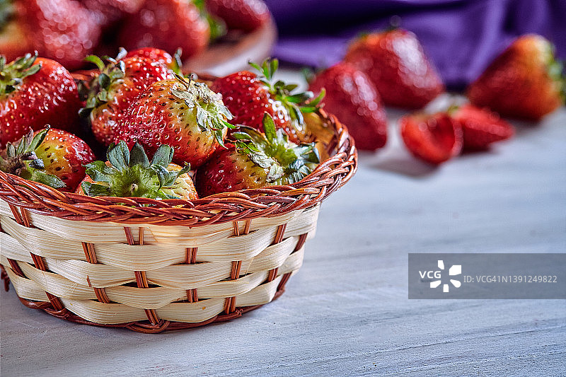 新鲜的红草莓放在乡村木桌子上的篮子里图片素材