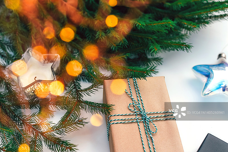 美丽的背景是一棵圣诞树的树枝，一个花环和玩具。新年的白色背景。圣诞节。图片素材