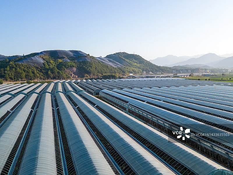 山顶太阳能发电厂和农场温室图片素材