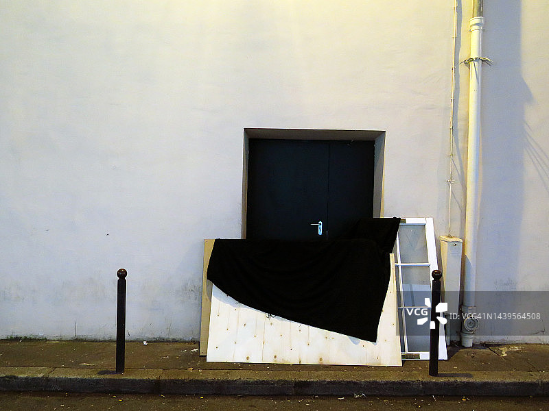 夜间丢弃在巴黎街道人行道上的建筑垃圾图片素材
