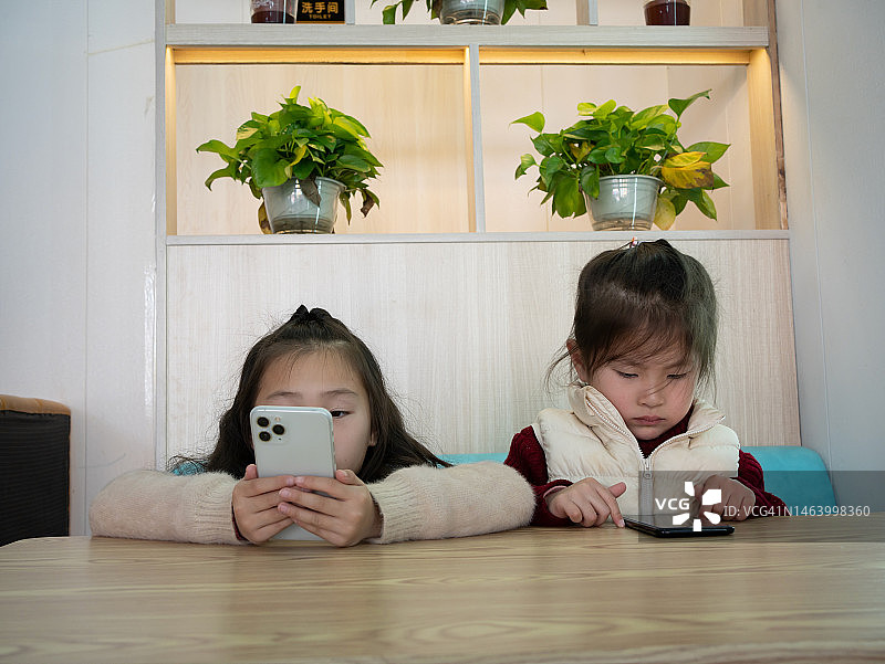 亚洲儿童沉迷于手机图片素材