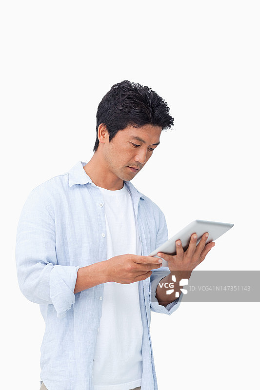 男性正在看他的平板电脑图片素材