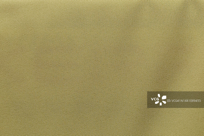黄色织物布涤纶纹理和纺织背景。图片素材