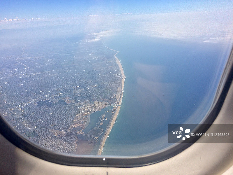 从飞机窗口鸟瞰海洋和陆地图片素材