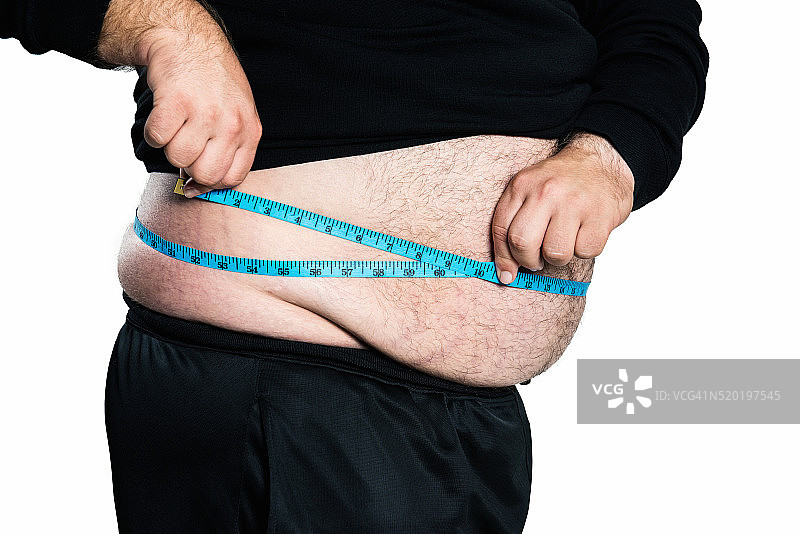 超重或用卷尺测量的胖子图片素材