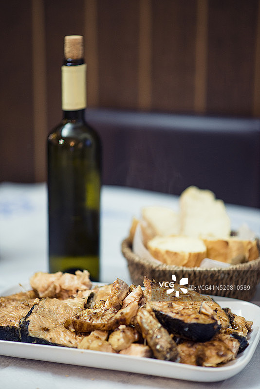 烤鲑鱼配一瓶白葡萄酒和面包图片素材