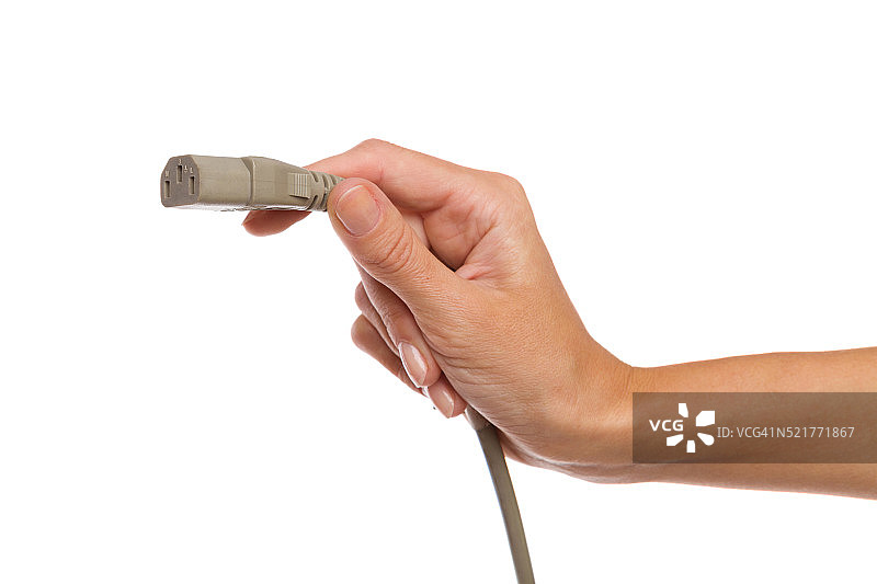 灰色IEC 3引脚电源插头，位于母手上图片素材