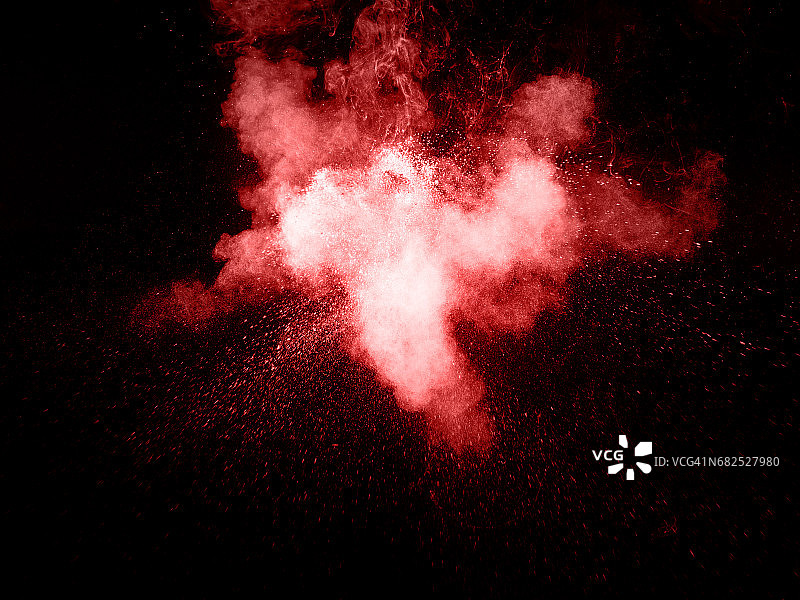 一种颜色的粉末爆炸的形式和纹理，红色的底部是黑色的图片素材