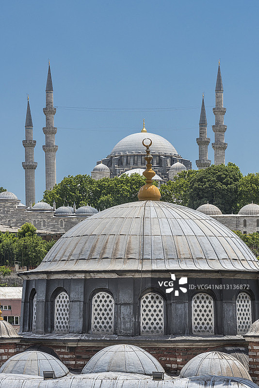 在伊斯坦布尔的一座小清真寺的库波拉后面，可以看到苏莱曼尼耶大清真寺图片素材