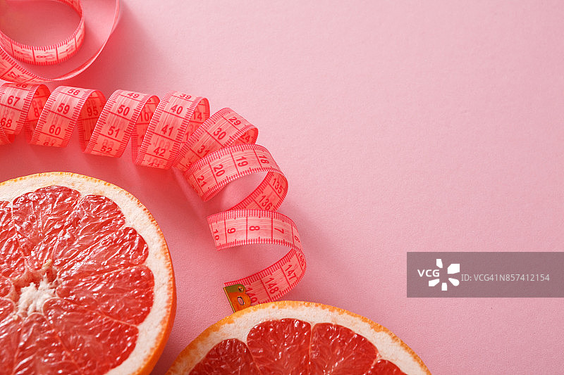 节食背景，柚子用卷尺测量图片素材