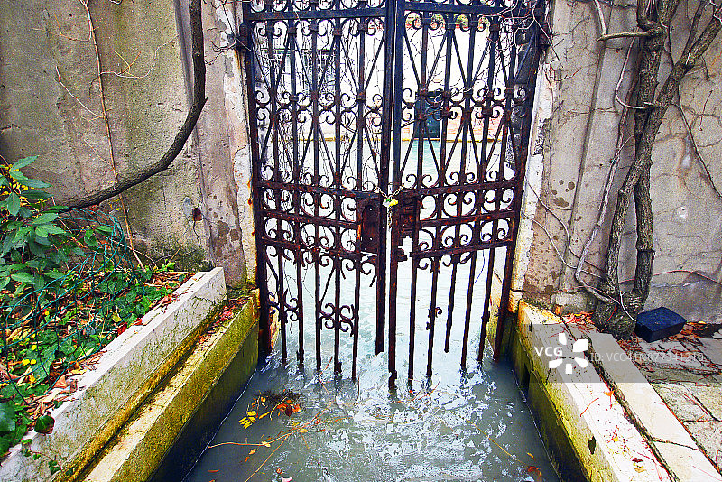 淹水的威尼斯花园大门通向运河图片素材