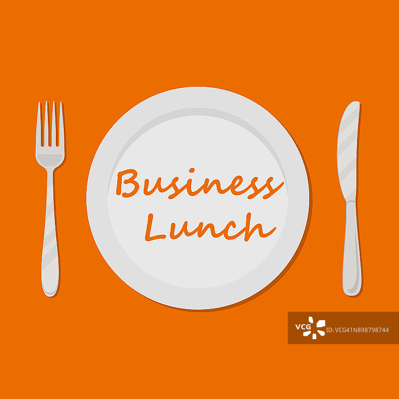 商务午餐的概念。橙色背景上刻有“商务午餐”字样的盘子图片素材