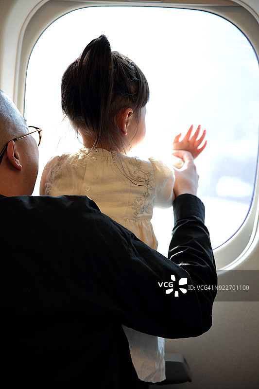 父亲和女儿望着窗外图片素材
