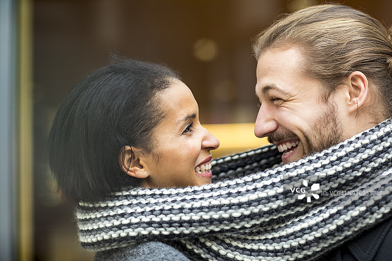 幸福的年轻夫妇分享围巾肖像图片素材