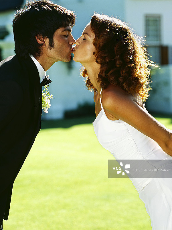 新婚夫妇接吻的侧影图片素材