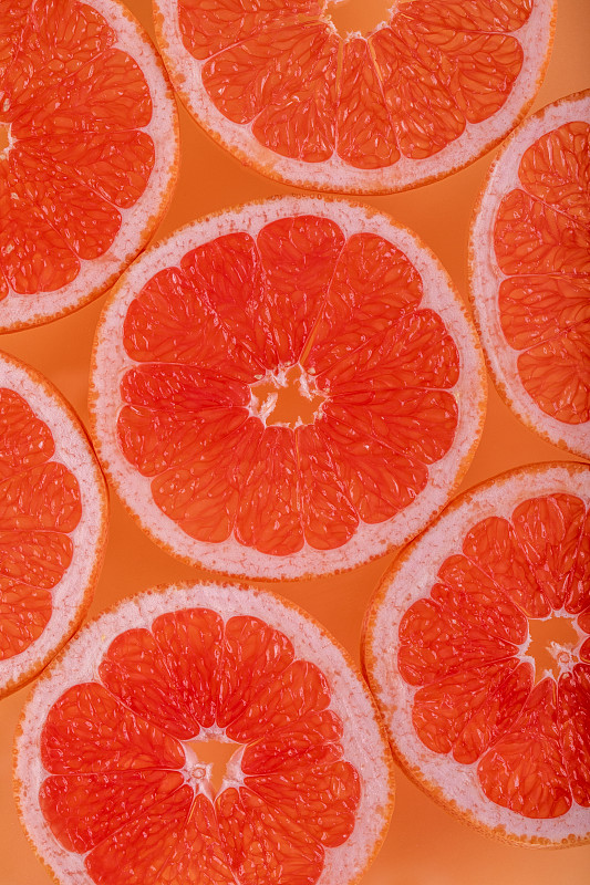 七片切片台湾红宝石葡萄柚-橘色背景图片素材