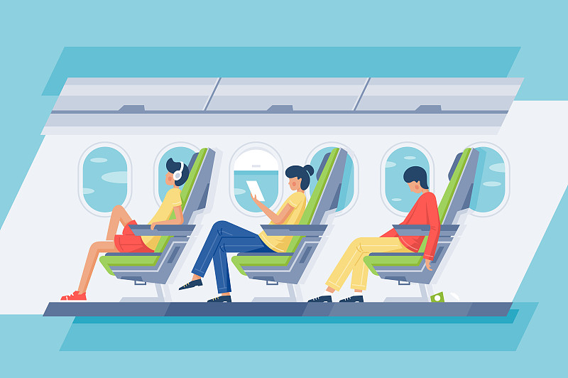 男乘客和女乘客带着耳机和书在飞机上放松。图片下载